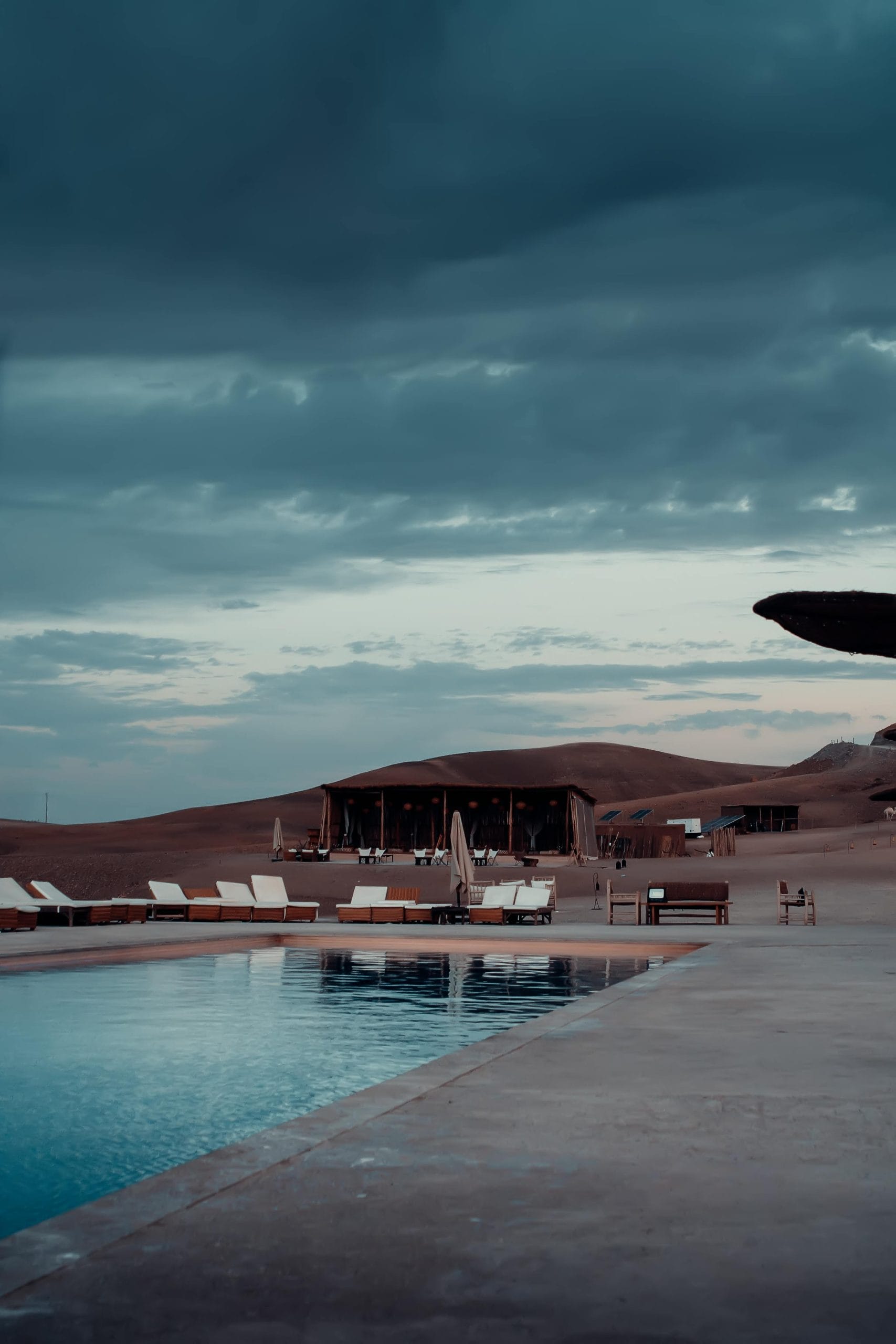 A serene luxury desert glamping setup under a golden sunset