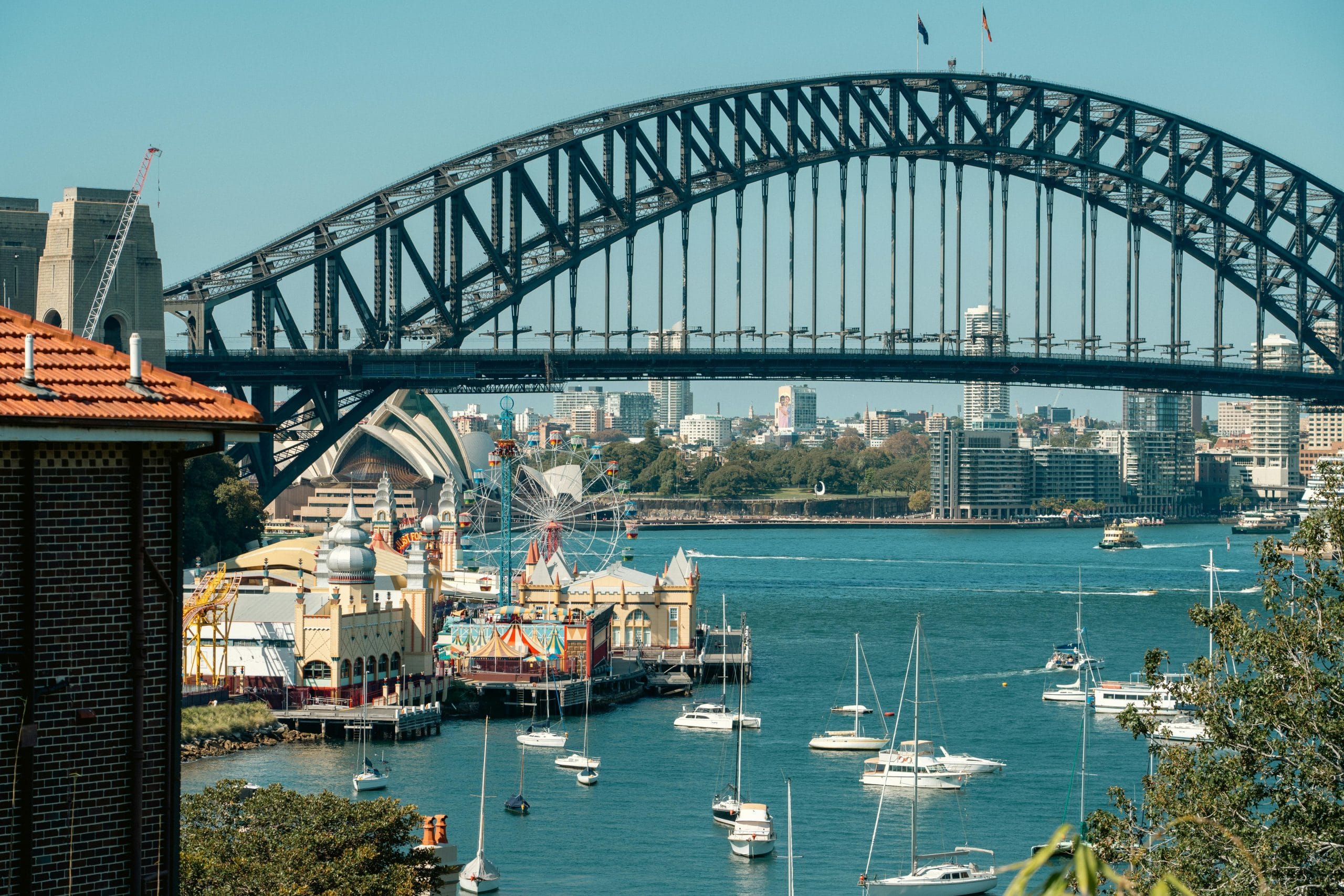 An elegant balcony overlooking Sydney harbor-view luxury hotels and the Opera House.