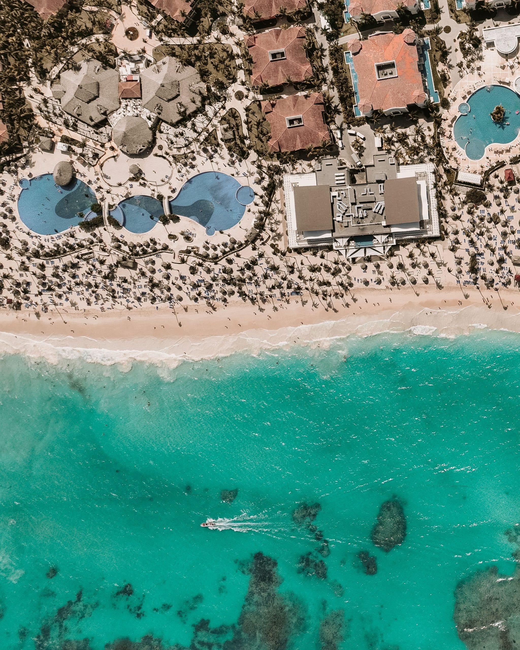 A serene view of luxury adult-only beach resorts at sunset