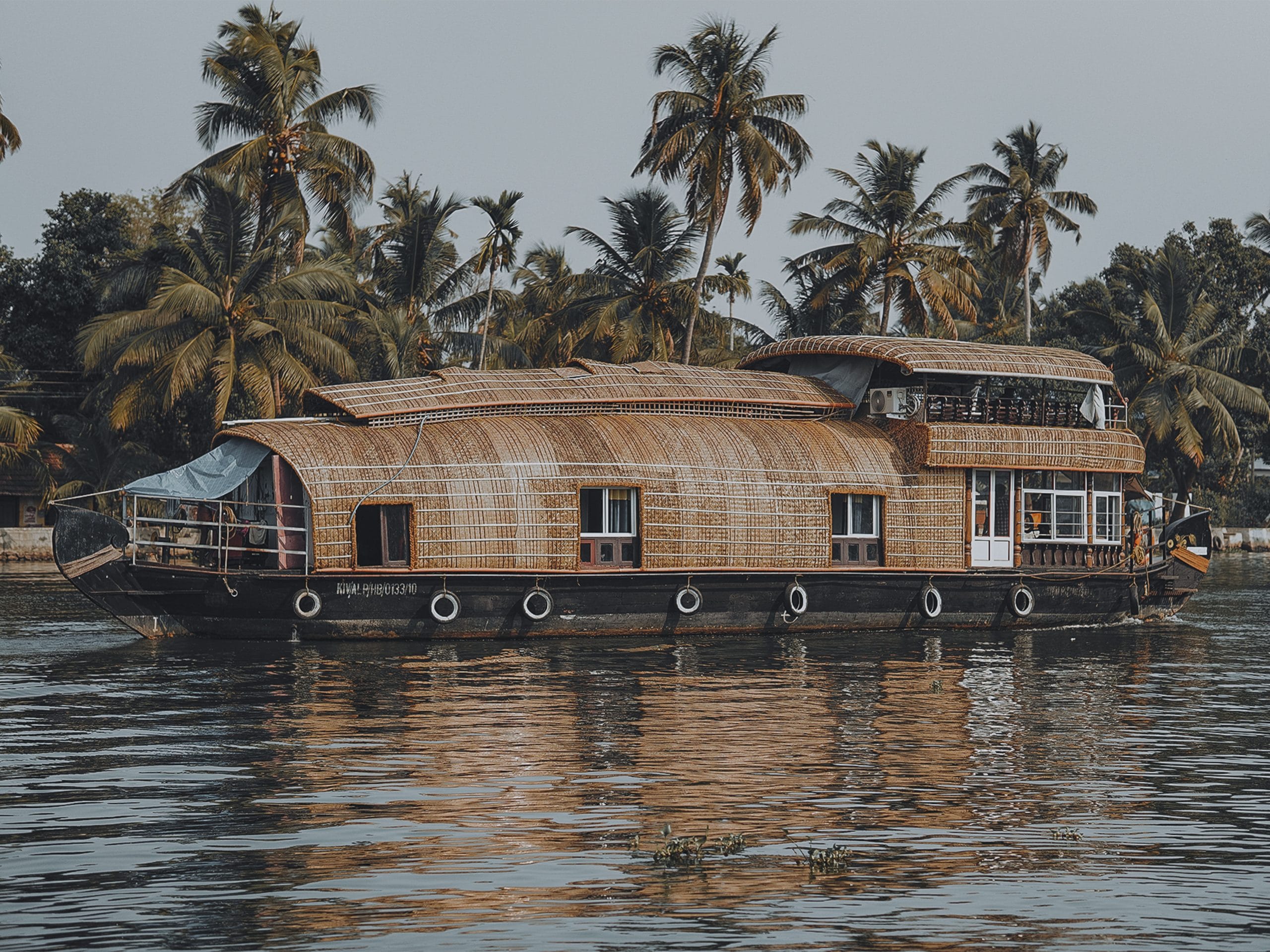A serene luxury houseboat Kerala drifting through backwaters