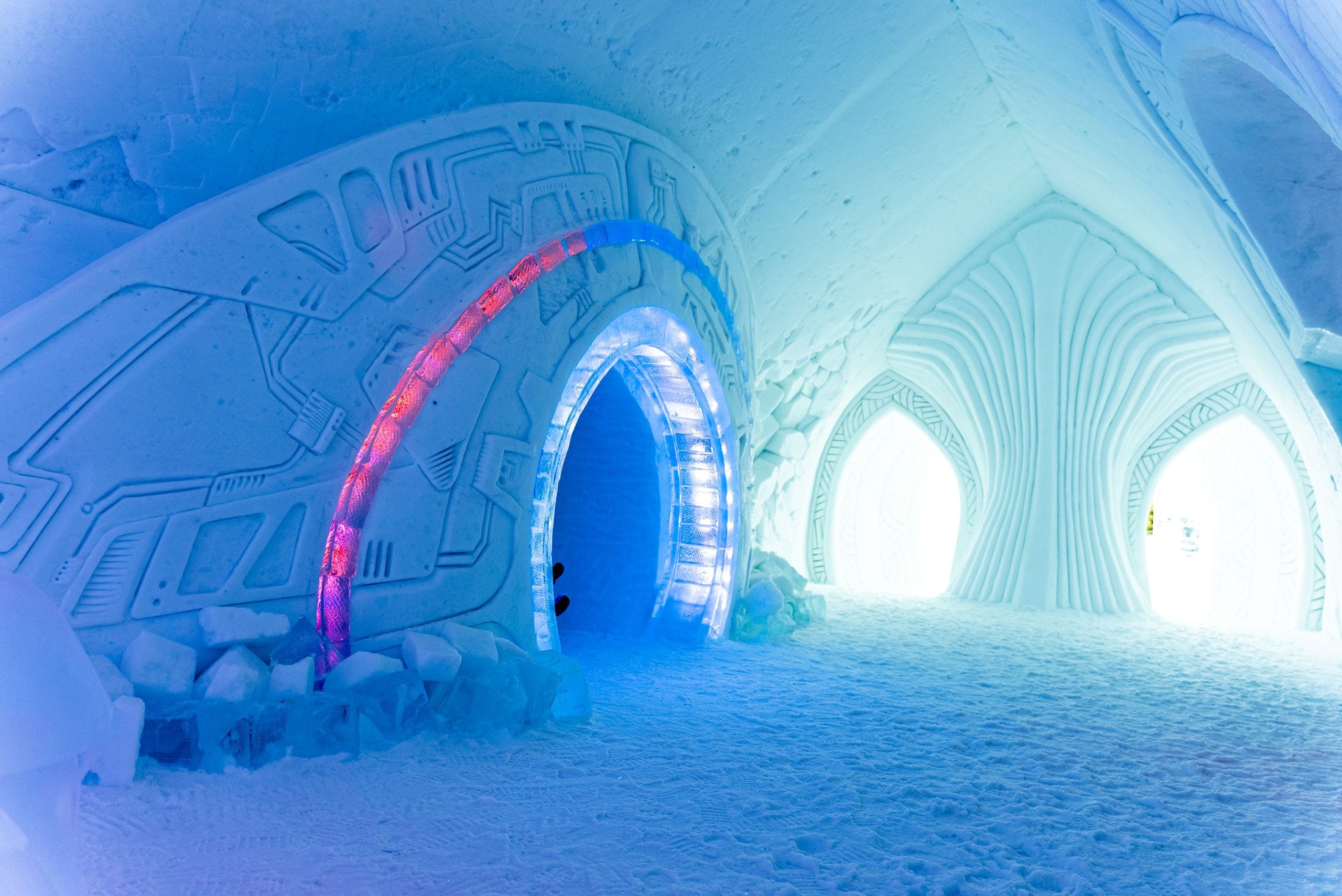 A serene evening view of luxury ice hotels under the Northern Lights
