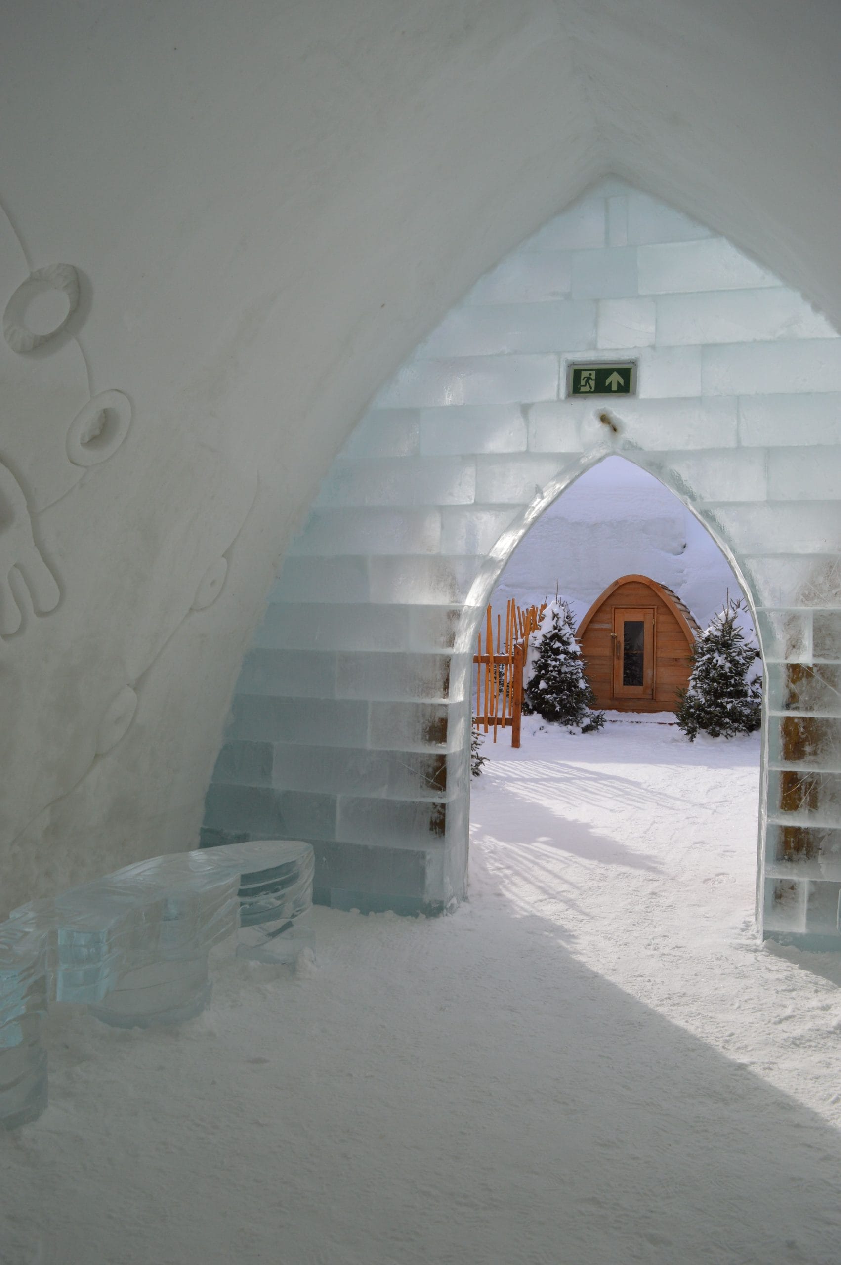 A serene evening view of luxury ice hotels under the Northern Lights