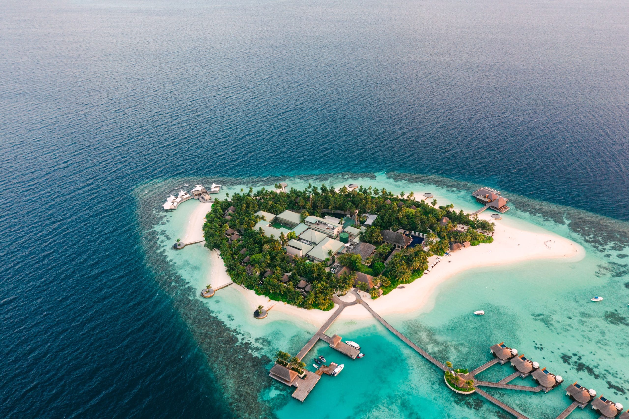 A serene aerial view of secluded luxury island getaways with turquoise water