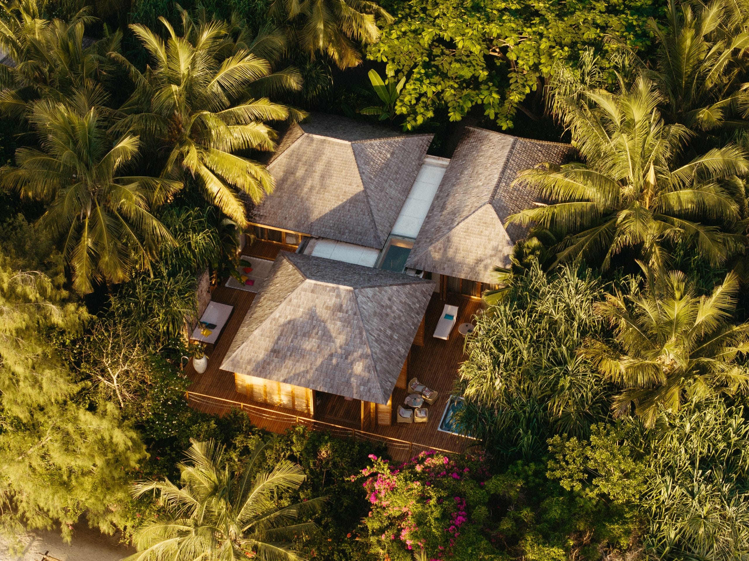 A serene aerial view of secluded luxury island getaways with turquoise water