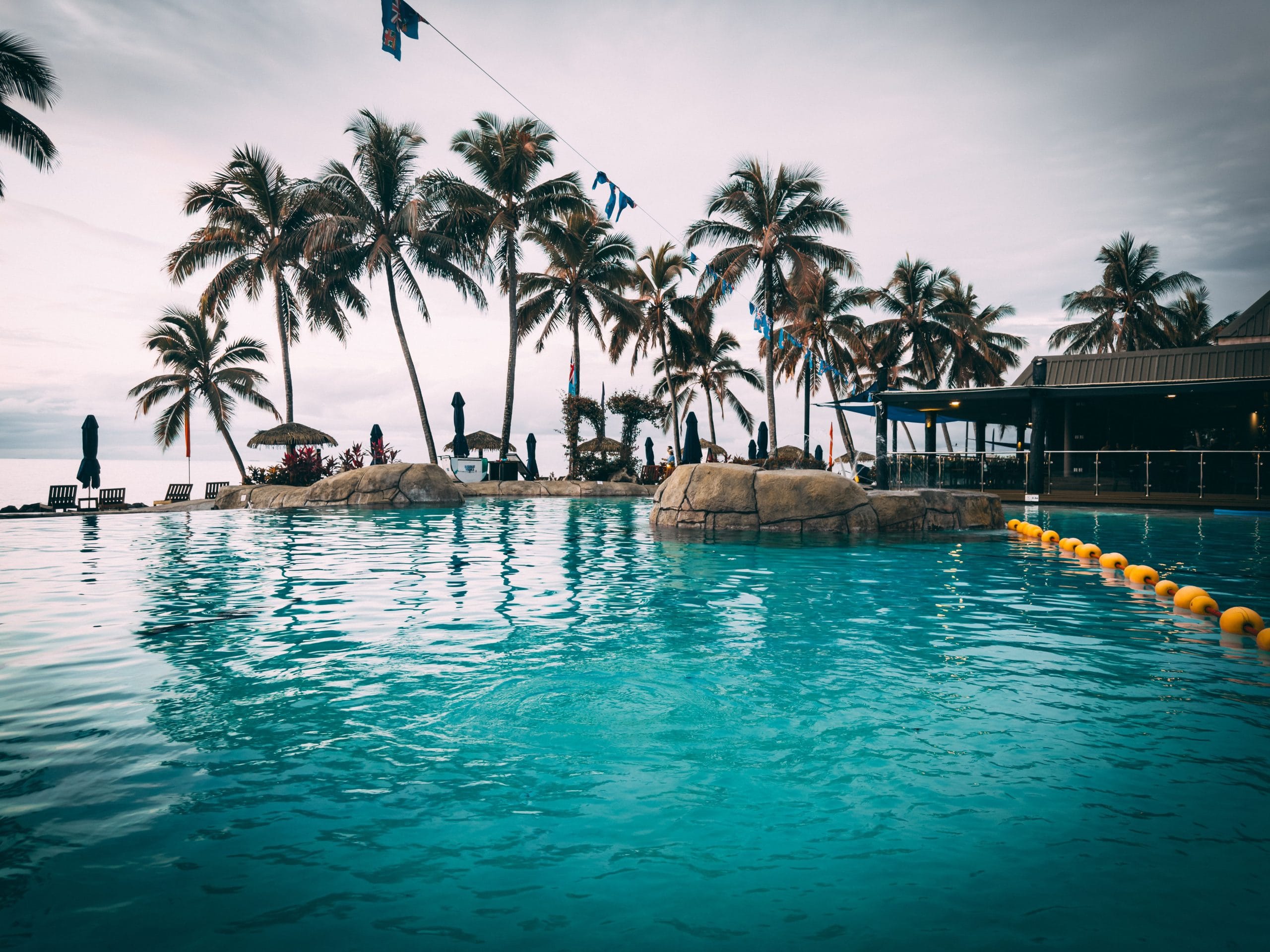 Experience Serenity at Fiji Luxury Beachfront Retreats A serene view of Fiji luxury beachfront retreats under a soft morning sky.