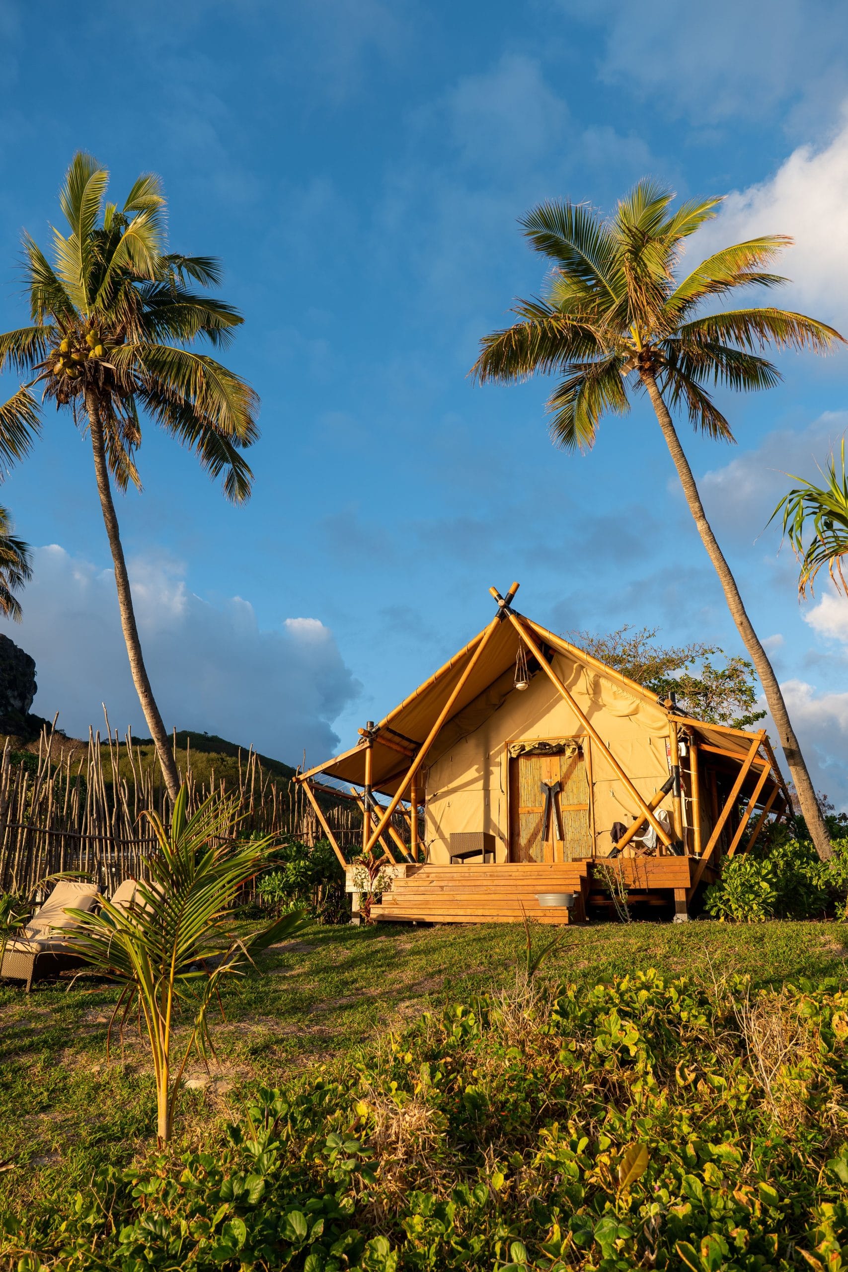 Experience Serenity at Fiji Luxury Beachfront Retreats A serene view of Fiji luxury beachfront retreats under a soft morning sky.