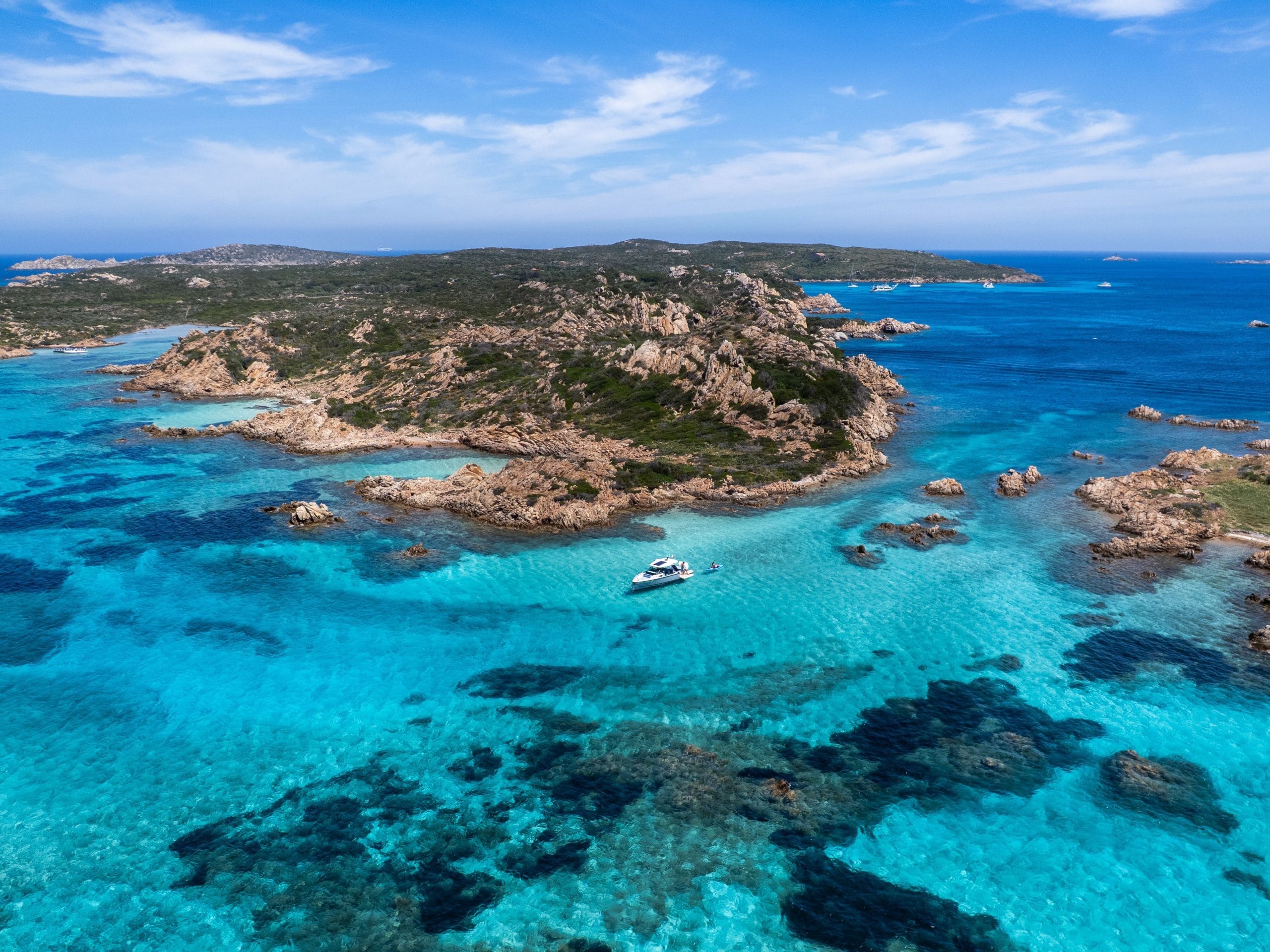 A serene view of Sardinia luxury beachfront retreats at sunset