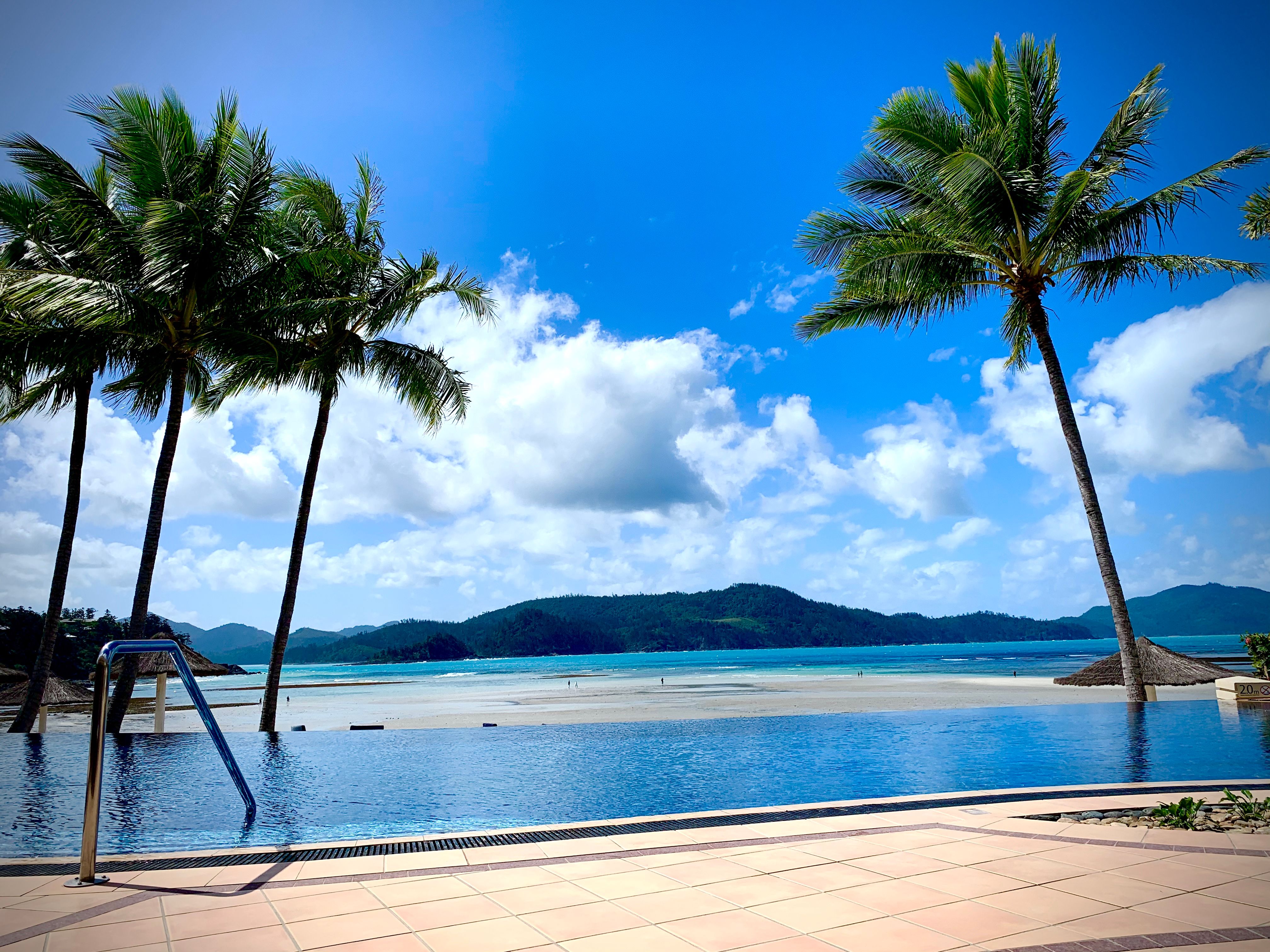 A serene view of Whitsundays luxury beachfront retreats overlooking the turquoise ocean.