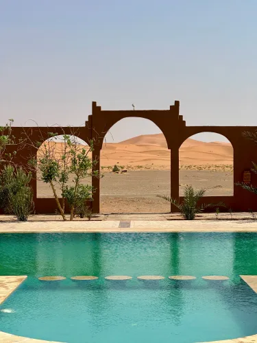 A serene view of luxury Sahara Desert escapes at sunset