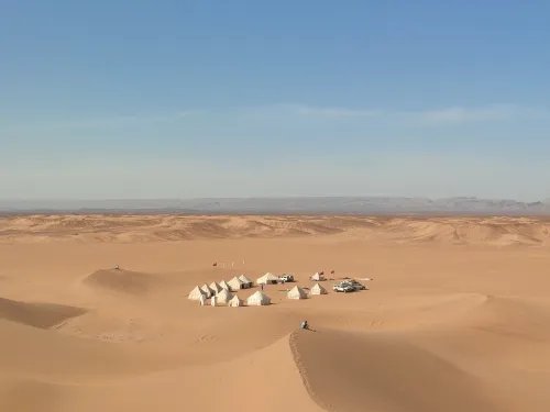 A serene view of luxury Sahara Desert escapes at sunset